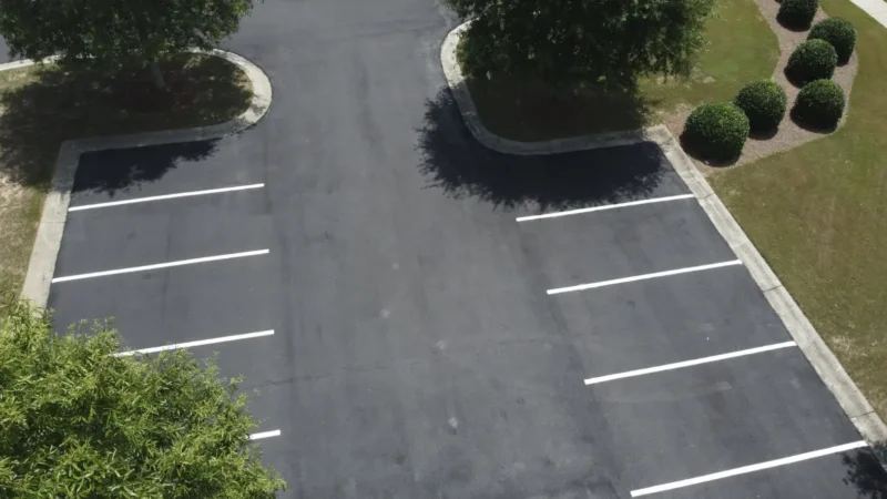 Aerial view of a parking lot that has been milled, repaved and restriped.