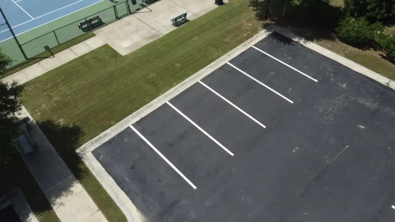 Aerial view of a parking lot that has been milled, repaved and restriped.