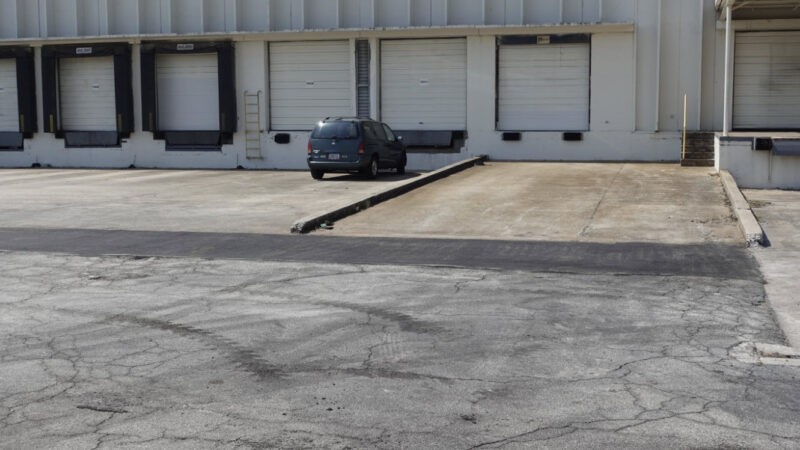 Photo of a truck court that has damage to it.