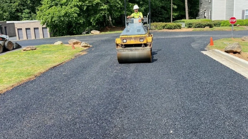 GWP worker using a machine to smooth the asphalt.