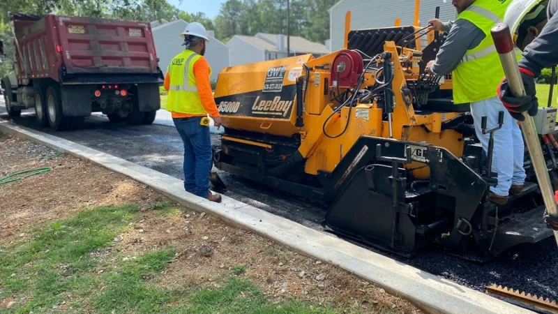 GWP Workers can be seen using machines and tools to work on a parking lot.