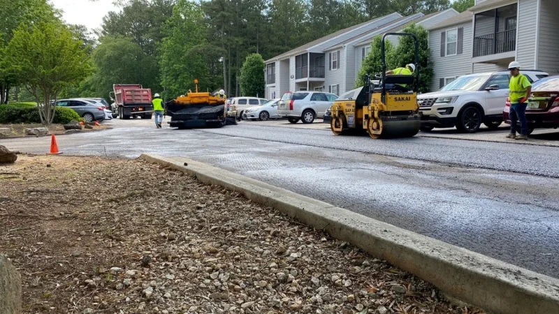 GWP Workers can be seen using machines and tools to work on a parking lot.